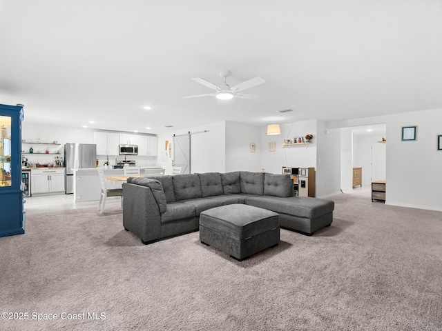 2926 Tishman Rd SE, Palm Bay, FL 32909 - living area with light colored carpet, ceiling fan, a barn door, and recessed lighting