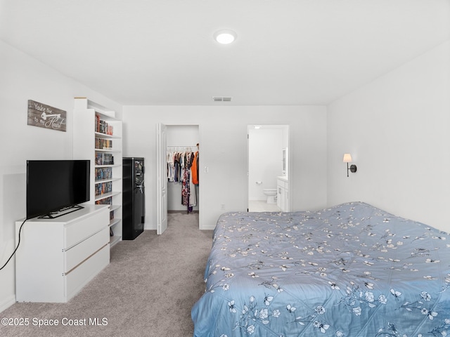 2926 Tishman Rd SE, Palm Bay, FL 32909 - bedroom featuring light colored carpet, a spacious closet, a closet, and ensuite bath