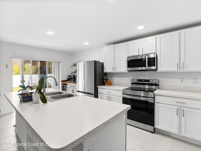 2926 Tishman Rd SE, Palm Bay, FL 32909 - kitchen with appliances with stainless steel finishes, light tile patterned floors, white cabinetry, light countertops, and recessed lighting