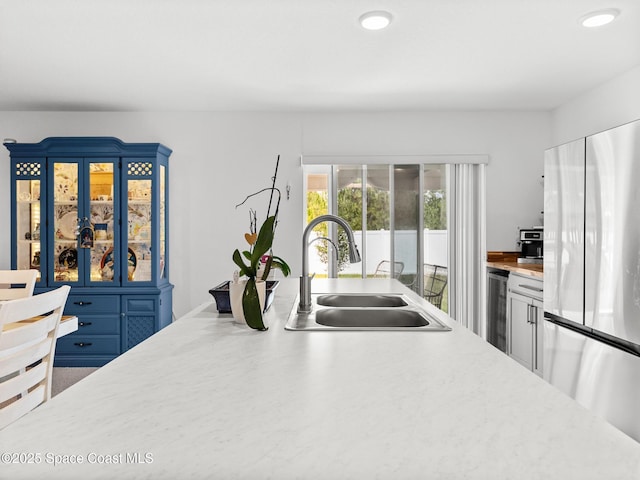 2926 Tishman Rd SE, Palm Bay, FL 32909 - kitchen featuring freestanding refrigerator, beverage cooler, light countertops, and recessed lighting