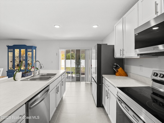 2926 Tishman Rd SE, Palm Bay, FL 32909 - kitchen with appliances with stainless steel finishes, light countertops, white cabinetry, and recessed lighting