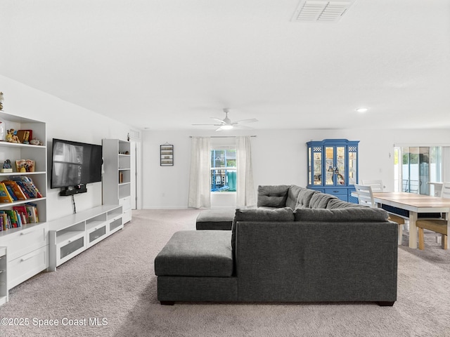 2926 Tishman Rd SE, Palm Bay, FL 32909 - living room with carpet floors, plenty of natural light, and a ceiling fan