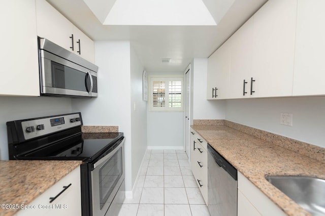 1049 Rockledge Dr Unit 507B, Rockledge, FL 32955 - kitchen featuring stainless steel appliances, light marble finish floors, white cabinets, and light stone counters