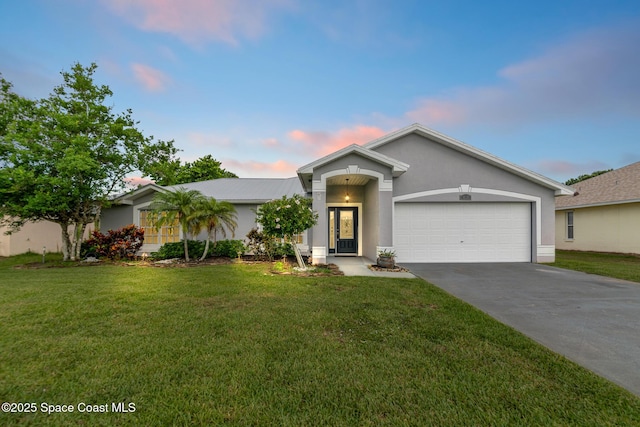 897 Hunters Creek Dr, Melbourne, FL 32904 - ranch-style home with an attached garage, driveway, stucco siding, and a yard
