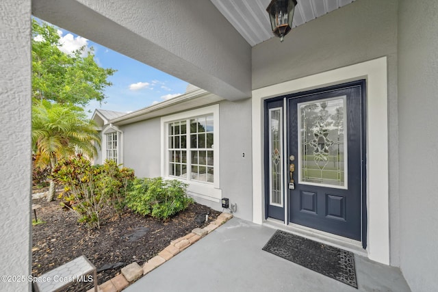 897 Hunters Creek Dr, Melbourne, FL 32904 - view of exterior entry featuring stucco siding