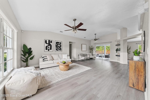 897 Hunters Creek Dr, Melbourne, FL 32904 - living area with lofted ceiling, ceiling fan, and light wood-type flooring