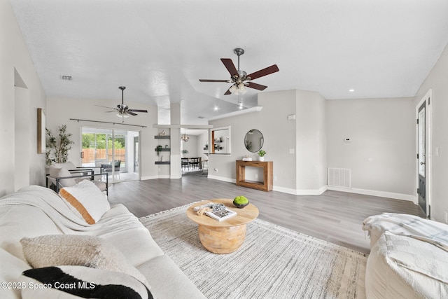 897 Hunters Creek Dr, Melbourne, FL 32904 - living area with ceiling fan, wood finished floors, recessed lighting, and vaulted ceiling