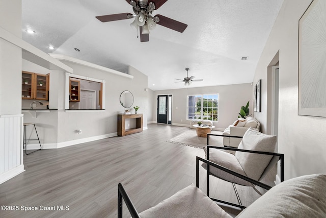 897 Hunters Creek Dr, Melbourne, FL 32904 - living area featuring vaulted ceiling, ceiling fan, light wood-style floors, and recessed lighting