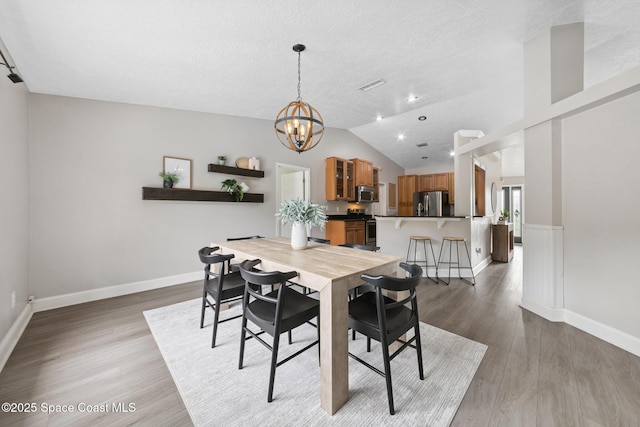 897 Hunters Creek Dr, Melbourne, FL 32904 - dining space featuring a chandelier, light wood finished floors, and lofted ceiling