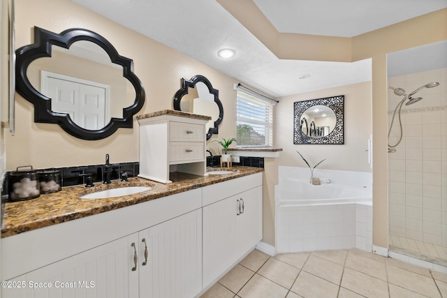897 Hunters Creek Dr, Melbourne, FL 32904 - full bath with a bath, tiled shower, double vanity, and tile patterned flooring