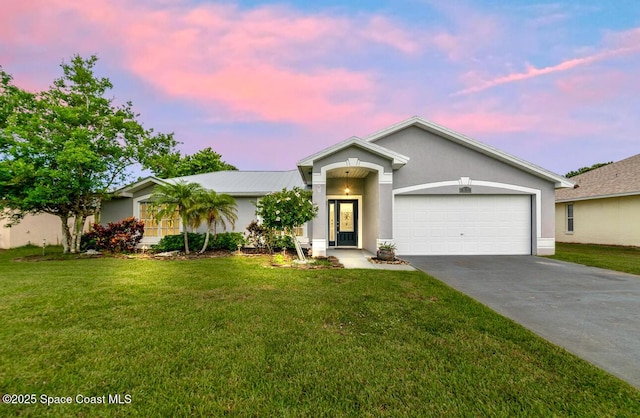 897 Hunters Creek Dr, Melbourne, FL 32904 - single story home featuring a garage, concrete driveway, a front yard, and stucco siding