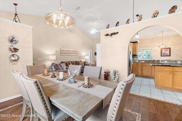 4808 Springwater Cir, Melbourne, FL 32940 - dining room with a ceiling fan, light wood finished floors, arched walkways, and lofted ceiling