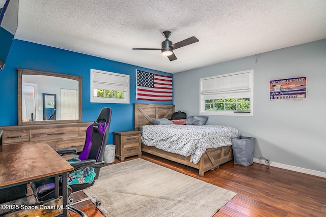 3384 Elizabeth St, West Melbourne, FL 32904 - bedroom with wood finished floors, a ceiling fan, a textured ceiling, and a desk