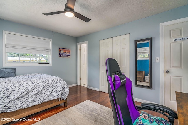 3384 Elizabeth St, West Melbourne, FL 32904 - bedroom featuring dark wood-style flooring, a closet, a textured ceiling, and ceiling fan
