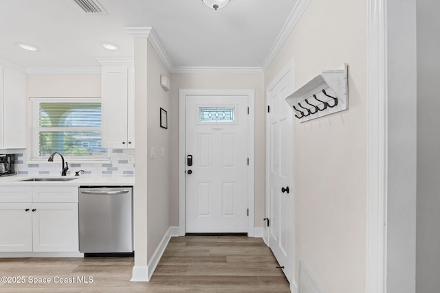 430 Watts Way, Cocoa Beach, FL 32931 - doorway featuring light wood-style flooring and crown molding