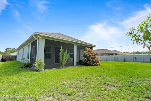 416 Ladyslipper St, Palm Bay, FL 32908 - rear view of house featuring a sunroom, a fenced backyard, and stucco siding