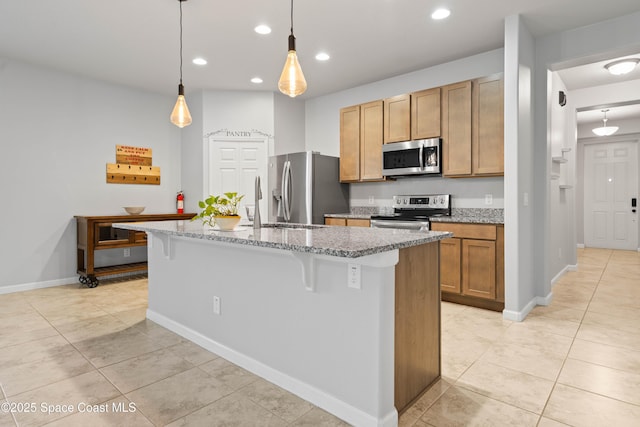 416 Ladyslipper St, Palm Bay, FL 32908 - kitchen with stainless steel appliances, recessed lighting, a breakfast bar, light tile patterned floors, and a center island with sink