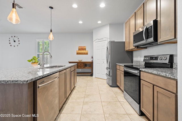 416 Ladyslipper St, Palm Bay, FL 32908 - kitchen featuring appliances with stainless steel finishes, recessed lighting, light tile patterned floors, a center island with sink, and hanging light fixtures