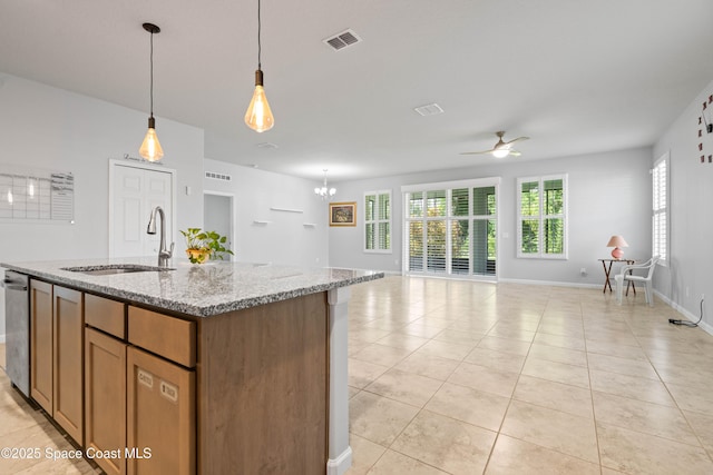 416 Ladyslipper St, Palm Bay, FL 32908 - kitchen featuring ceiling fan, open floor plan, light tile patterned floors, light stone counters, and decorative light fixtures