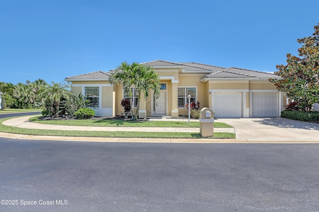 143 Sanibel Way, Melbourne Beach, FL 32951 - view of front of house with a garage, concrete driveway, stucco siding, and a tiled roof