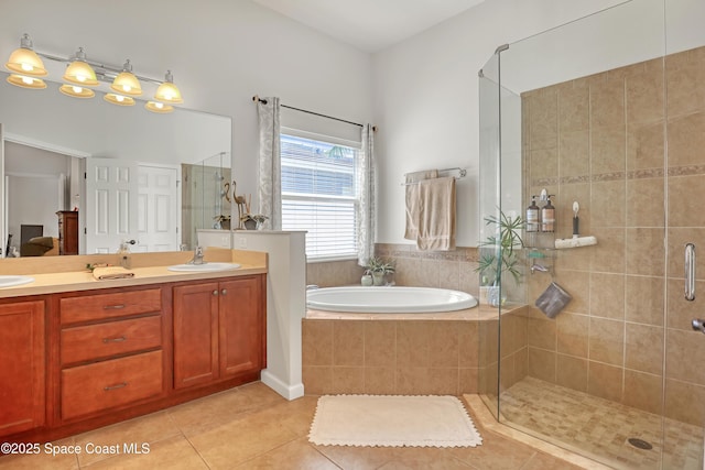 143 Sanibel Way, Melbourne Beach, FL 32951 - full bathroom featuring tile patterned flooring, a bath, a shower stall, and double vanity