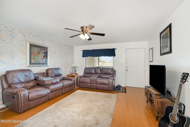 1515 Huntington Ln Unit 423, Rockledge, FL 32955 - living area with wallpapered walls, light wood-type flooring, ceiling fan, and an accent wall