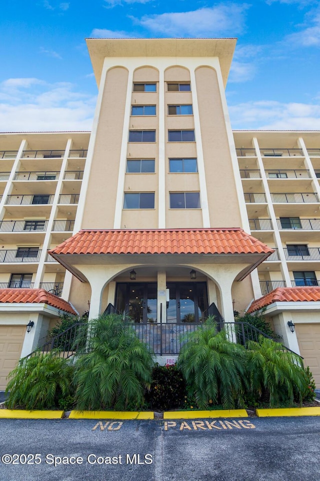 2815 S Atlantic Ave Unit 606, Cocoa Beach, FL 32931 - view of apartment building / complex with uncovered parking