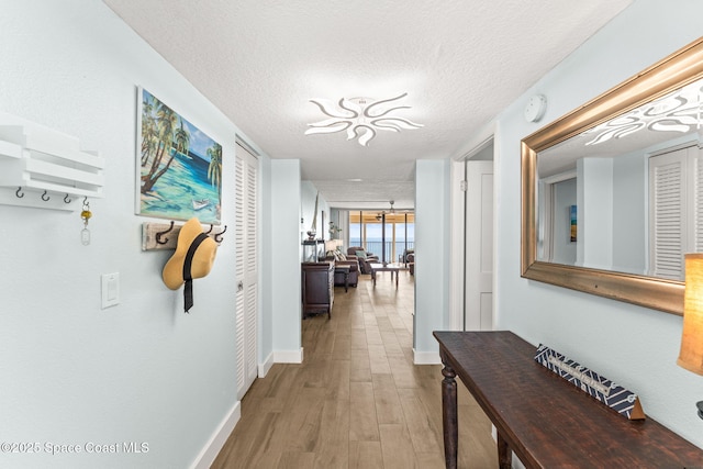 2815 S Atlantic Ave Unit 606, Cocoa Beach, FL 32931 - hallway with wood finished floors and a textured ceiling