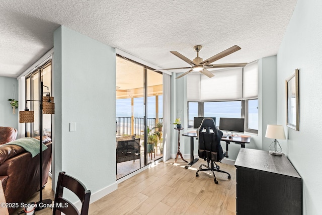 2815 S Atlantic Ave Unit 606, Cocoa Beach, FL 32931 - office featuring wood finished floors, a ceiling fan, a textured ceiling, and healthy amount of natural light