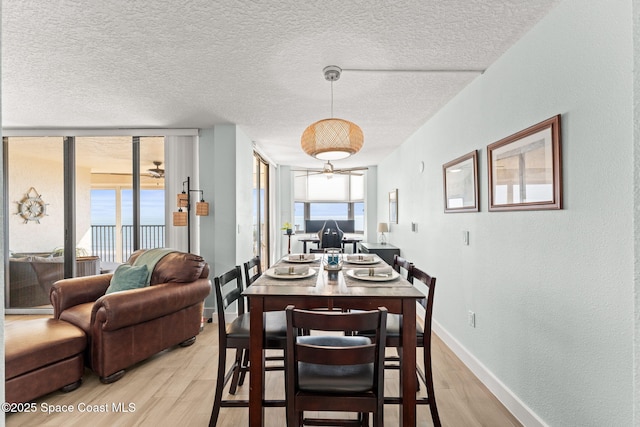 2815 S Atlantic Ave Unit 606, Cocoa Beach, FL 32931 - dining room with light wood-style floors and a textured ceiling