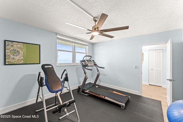 2815 S Atlantic Ave Unit 606, Cocoa Beach, FL 32931 - workout room featuring a ceiling fan and a textured ceiling