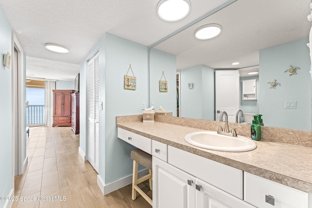 2815 S Atlantic Ave Unit 606, Cocoa Beach, FL 32931 - bathroom featuring a textured ceiling and vanity