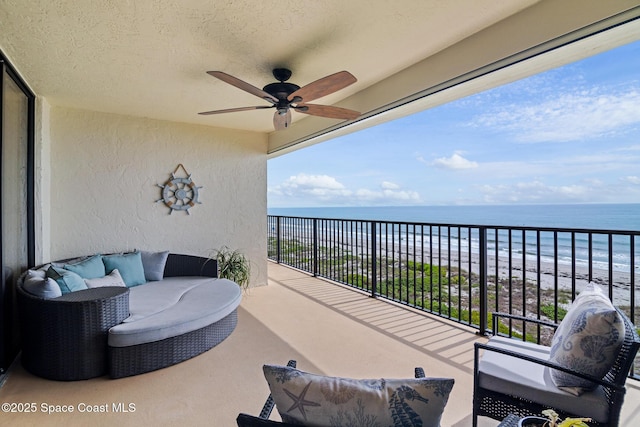 2815 S Atlantic Ave Unit 606, Cocoa Beach, FL 32931 - balcony featuring view of water and beach, ceiling fan, and outdoor lounge area