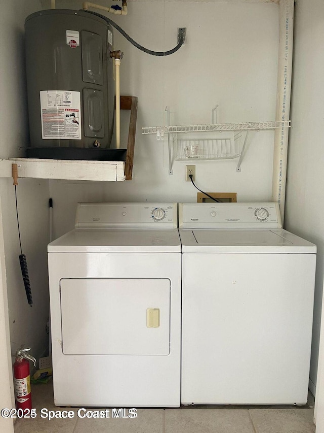 4670 Beck Lake Trl Unit 1-119, Melbourne, FL 32901 - washroom with washing machine and clothes dryer, water heater, and tile patterned flooring