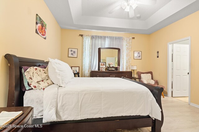 758 Carriage Lake Way, Vero Beach, FL 32968 - bedroom with a raised ceiling and a ceiling fan