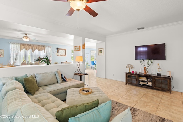 758 Carriage Lake Way, Vero Beach, FL 32968 - living room featuring a ceiling fan, ornamental molding, light tile patterned flooring, and plenty of natural light