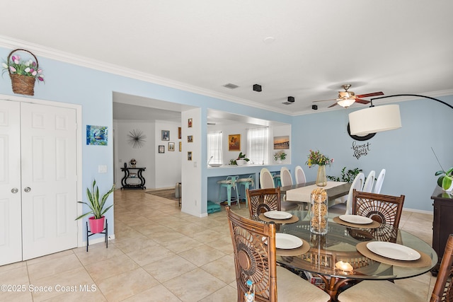 758 Carriage Lake Way, Vero Beach, FL 32968 - dining area with ceiling fan, light tile patterned floors, and crown molding