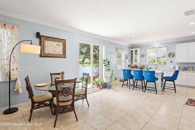 758 Carriage Lake Way, Vero Beach, FL 32968 - dining space with crown molding, healthy amount of natural light, light tile patterned flooring, and recessed lighting