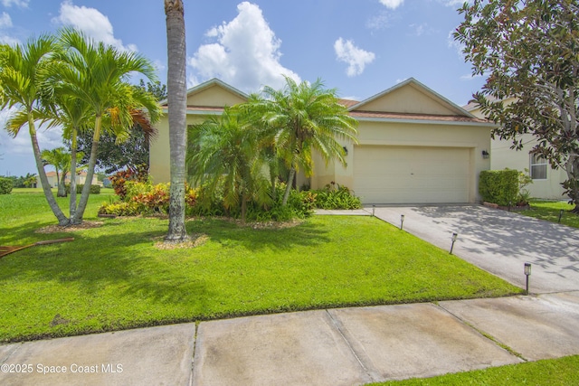 758 Carriage Lake Way, Vero Beach, FL 32968 - view of front of house featuring driveway, a garage, a front yard, and stucco siding