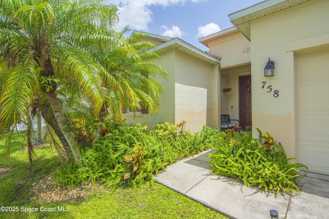 758 Carriage Lake Way, Vero Beach, FL 32968 - entrance to property featuring stucco siding and an attached garage