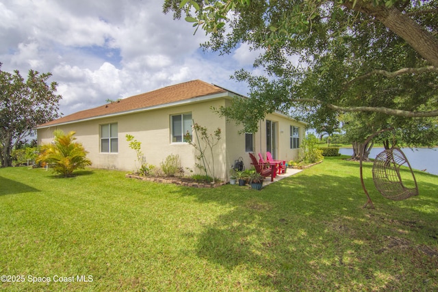 758 Carriage Lake Way, Vero Beach, FL 32968 - view of side of property featuring stucco siding, a yard, and a patio