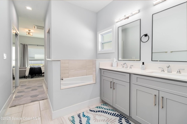 2840 Fontainebleau Ave SE, Palm Bay, FL 32909 - bathroom with double vanity, a garden tub, and tile patterned flooring