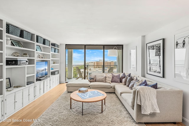 2100 N Atlantic Ave Unit 1110, Cocoa Beach, FL 32931 - living area featuring wood finished floors and expansive windows