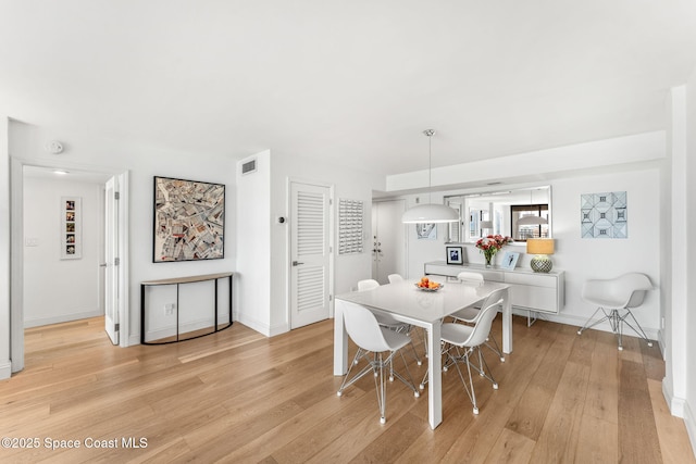 2100 N Atlantic Ave Unit 1110, Cocoa Beach, FL 32931 - dining room with light wood-type flooring and baseboards