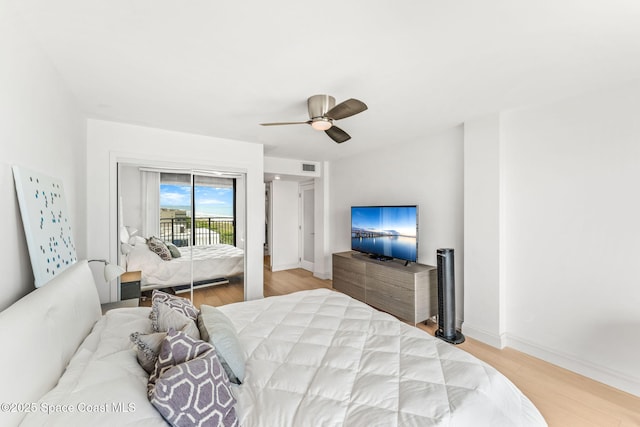 2100 N Atlantic Ave Unit 1110, Cocoa Beach, FL 32931 - bedroom with access to outside, light wood-type flooring, and a ceiling fan