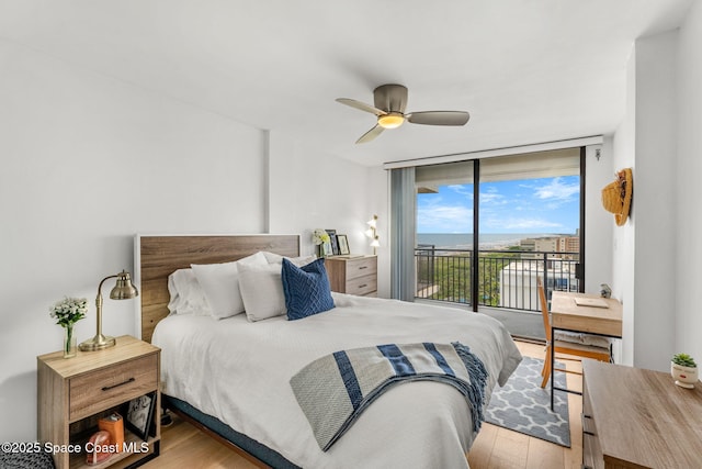 2100 N Atlantic Ave Unit 1110, Cocoa Beach, FL 32931 - bedroom with access to outside, wood finished floors, expansive windows, and ceiling fan