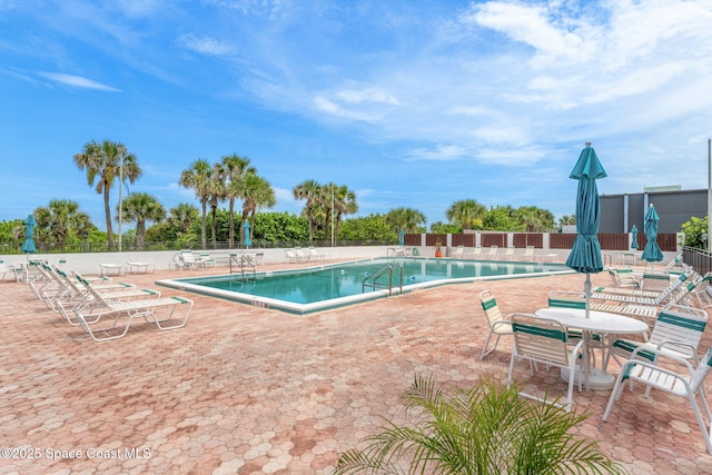 2100 N Atlantic Ave Unit 1110, Cocoa Beach, FL 32931 - community pool featuring a patio area