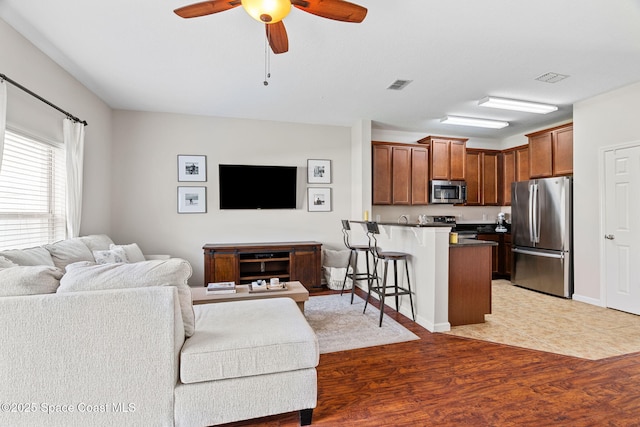 2710 Revolution St Unit 104, Melbourne, FL 32935 - living room with light wood-style floors and a ceiling fan