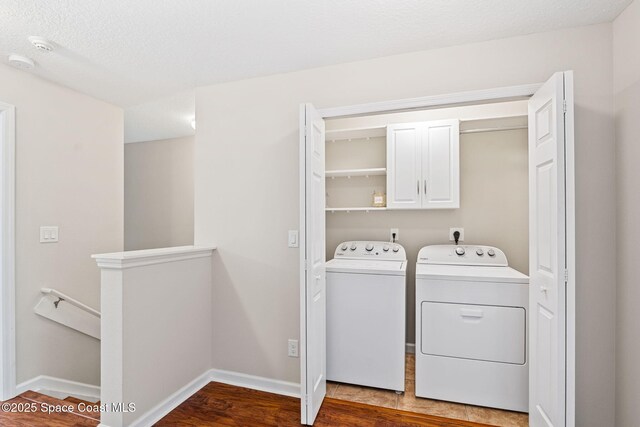 2710 Revolution St Unit 104, Melbourne, FL 32935 - laundry area with washing machine and dryer, wood finished floors, and cabinet space