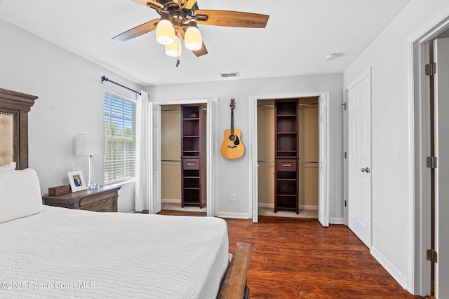 2710 Revolution St Unit 104, Melbourne, FL 32935 - bedroom with multiple closets, wood finished floors, a textured ceiling, and a ceiling fan